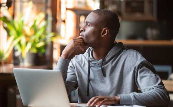 Student looking out of window thinking